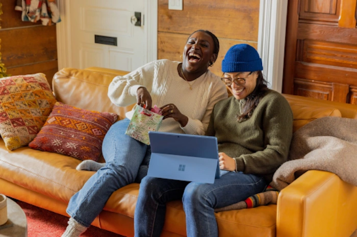 People laughing on a sofa