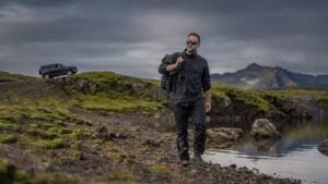 image of a walker by a lake wearing everything proof pants and shirt