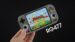 Close-up of the RG477M retro handheld console with a sleek metal design