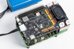 SunFounder Fusion HAT+ mounted on a Raspberry Pi 5, showing motor headers, servo ports, and battery connector.