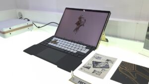 Limited ROG Flow Z13 with gold and black accents shown next to detachable RGB keyboard cover.