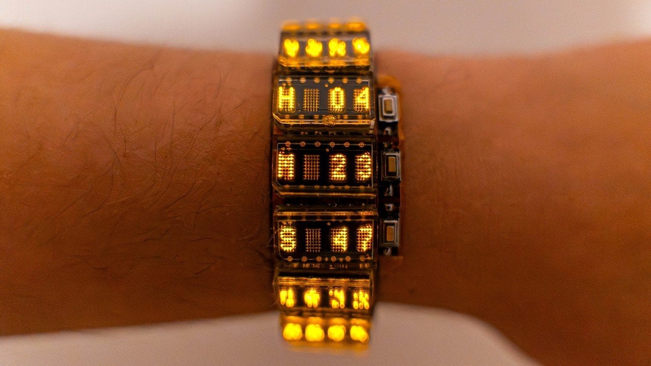 Watch screen showing a Matrix-style waterfall effect, with brightness turned up and battery drain noted by the builder.