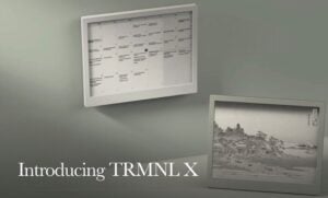 TRMNL X e-ink display on a desk showing a dashboard, highlighting the 10.3-inch screen and grayscale.