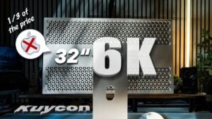 Kuycon G32P mounted on the optional stand, demonstrating height adjustment, tilt range, and portrait rotation.