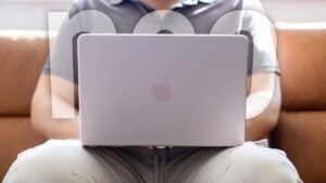 MacBook Neo screen displaying a bright webpage, highlighting the 500-nit Retina panel and thin bezels.