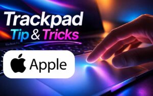 Hands swiping three fingers across a MacBook trackpad to switch between full-screen apps in macOS.