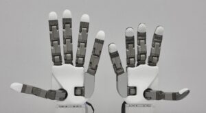 Tesollo DG-5F-S robotic hand mounted on a humanoid arm, showing its compact human-scale shape and wrist interface.