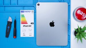 Battery pull tabs on the iPad Air M4 lifted during repair, showing removal without taking out the motherboard.
