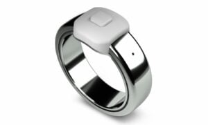 User pressing the microphone button on the matte black Pebble Index 01 smart ring