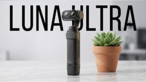 Person holding the lightweight Insta360 Luna Ultra camera outdoors to demonstrate portability.