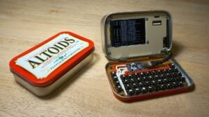 Open Altoids tin revealing a custom cyberdeck with an LCD screen