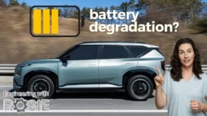 Mechanic inspecting the undercarriage of a used EV