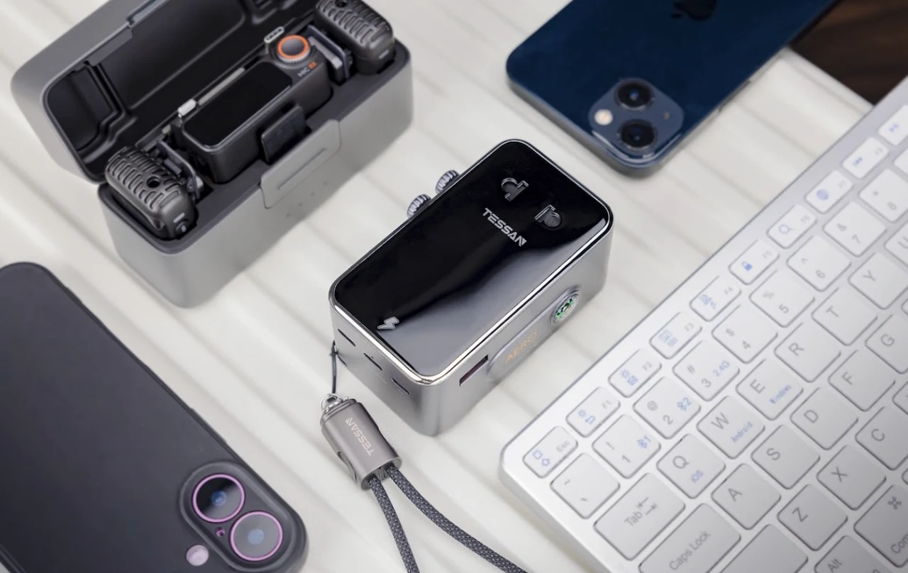 TESSAN AERO 70 on a desk beside a keyboard, two smartphones and an action camera