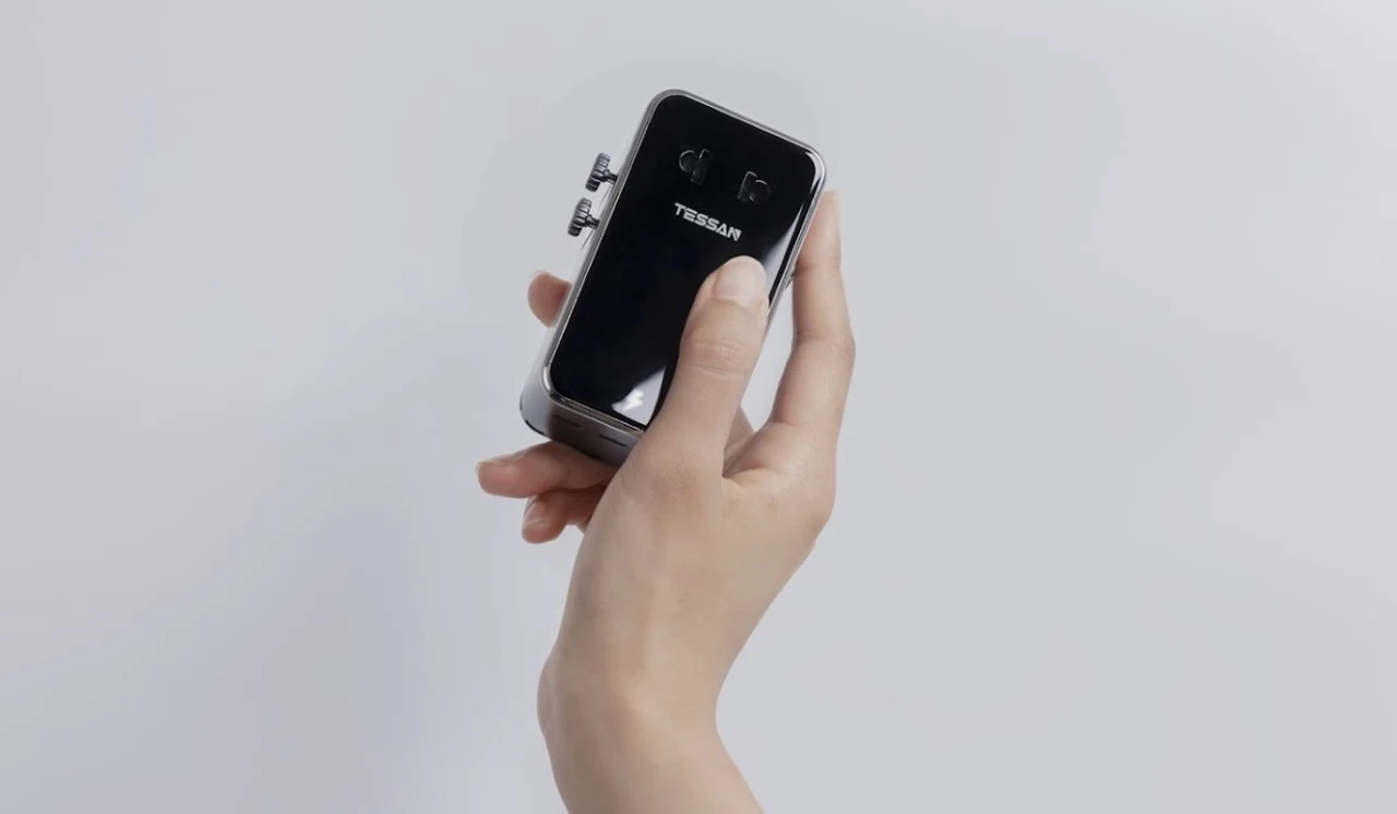 TESSAN AERO 70 ultra-thin travel adapter held in one hand to show its slim profile