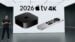 A black Apple TV 4K set-top box resting on a living room media console.