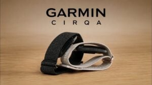 The Garmin CIRQA screenless fitness tracker resting on a table.