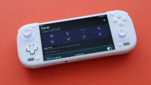 A person playing a game on an Android handheld device while monitoring system temperature.
