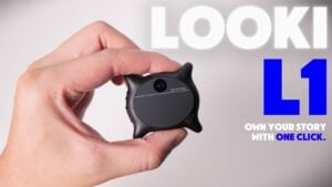 A close-up of the Looki L1 wearable camera resting in the palm of a hand.