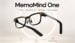 A close up of the MemoMind One smart glasses resting on a desk.