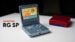 The Anbernic RG SP clamshell handheld resting on a desk.
