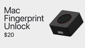 A custom desktop Touch ID device sitting on a desk next to a Mac computer.