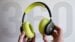 Black Beats 360 over-ear headphones resting on a wooden desk.
