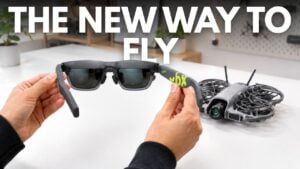 A drone pilot wearing lightweight AR glasses outdoors.