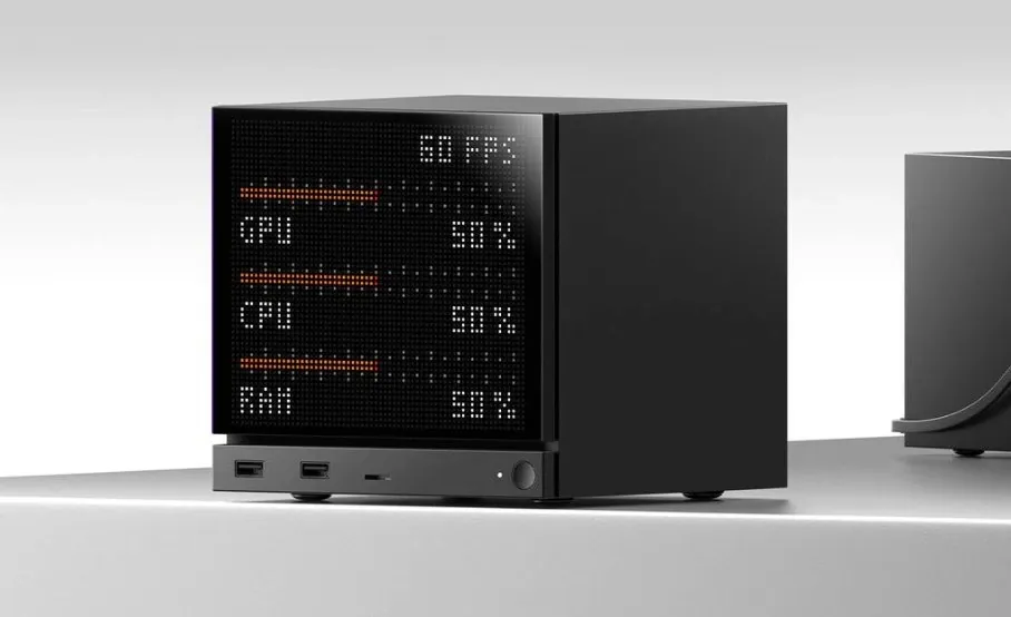 A JSAUX e-ink screen attached to the back of a Steam Deck displaying system performance data.