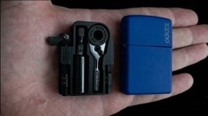 Open Zippo case revealing a custom micro toolkit inside