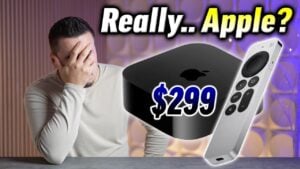 The new Apple TV 4K streaming box sitting next to a modern television.