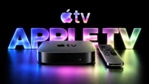 A black Apple TV 4K streaming box resting on a wooden media console.