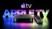 A black Apple TV 4K streaming box resting on a wooden media console.