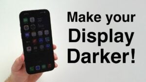 An iPhone in a dark room with a heavily dimmed display.