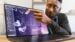 A person interacting with the new touchscreen on the OLED MacBook Pro.