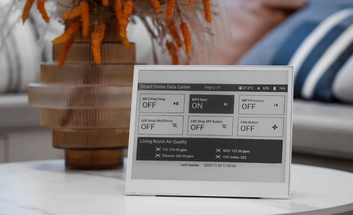 The 10.3-inch e-paper display mounted on a living room wall showing a grayscale photo.