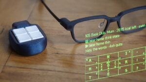 A person wearing smart glasses while working away from a traditional desk.