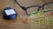 A person wearing smart glasses while working away from a traditional desk.