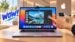 A conceptual render of a MacBook with a touchscreen display being tapped by a finger.