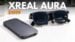 The XREAL Aura augmented reality glasses resting on a flat surface.